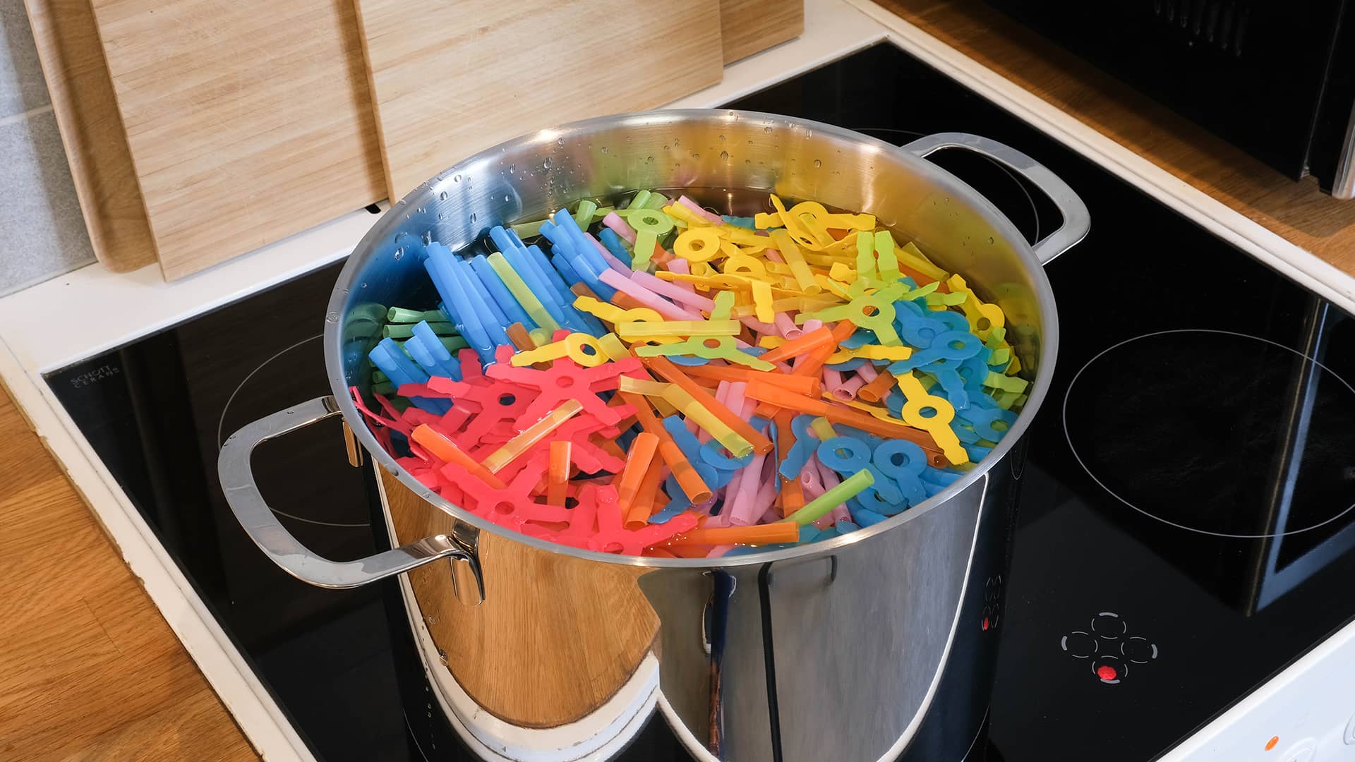 \[27] Boiling straws and connectors carefully in a large pot.